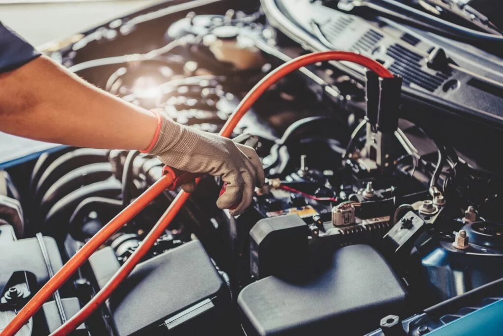 car mechanic diagnosing battery