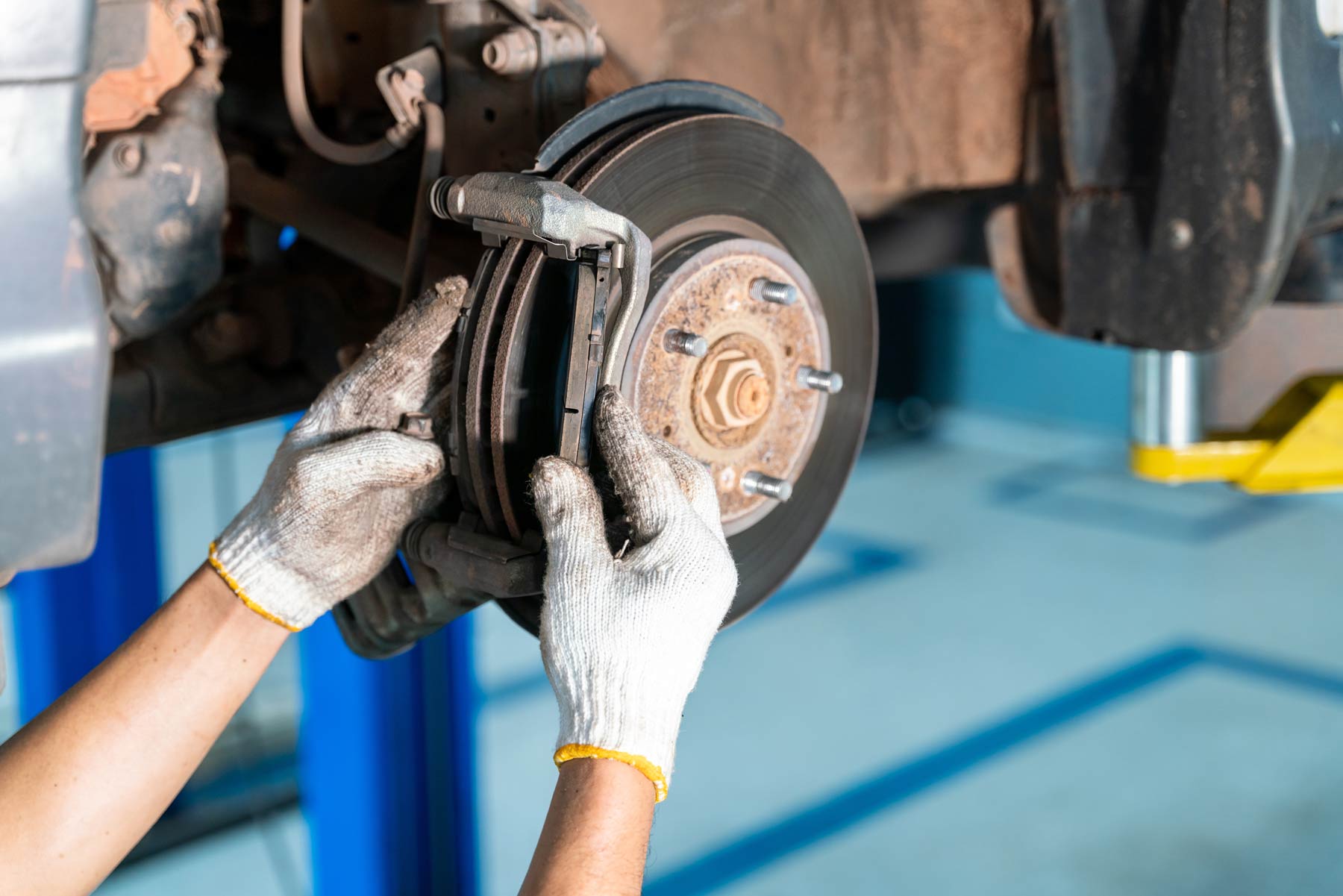 mechanic replacing brake pads